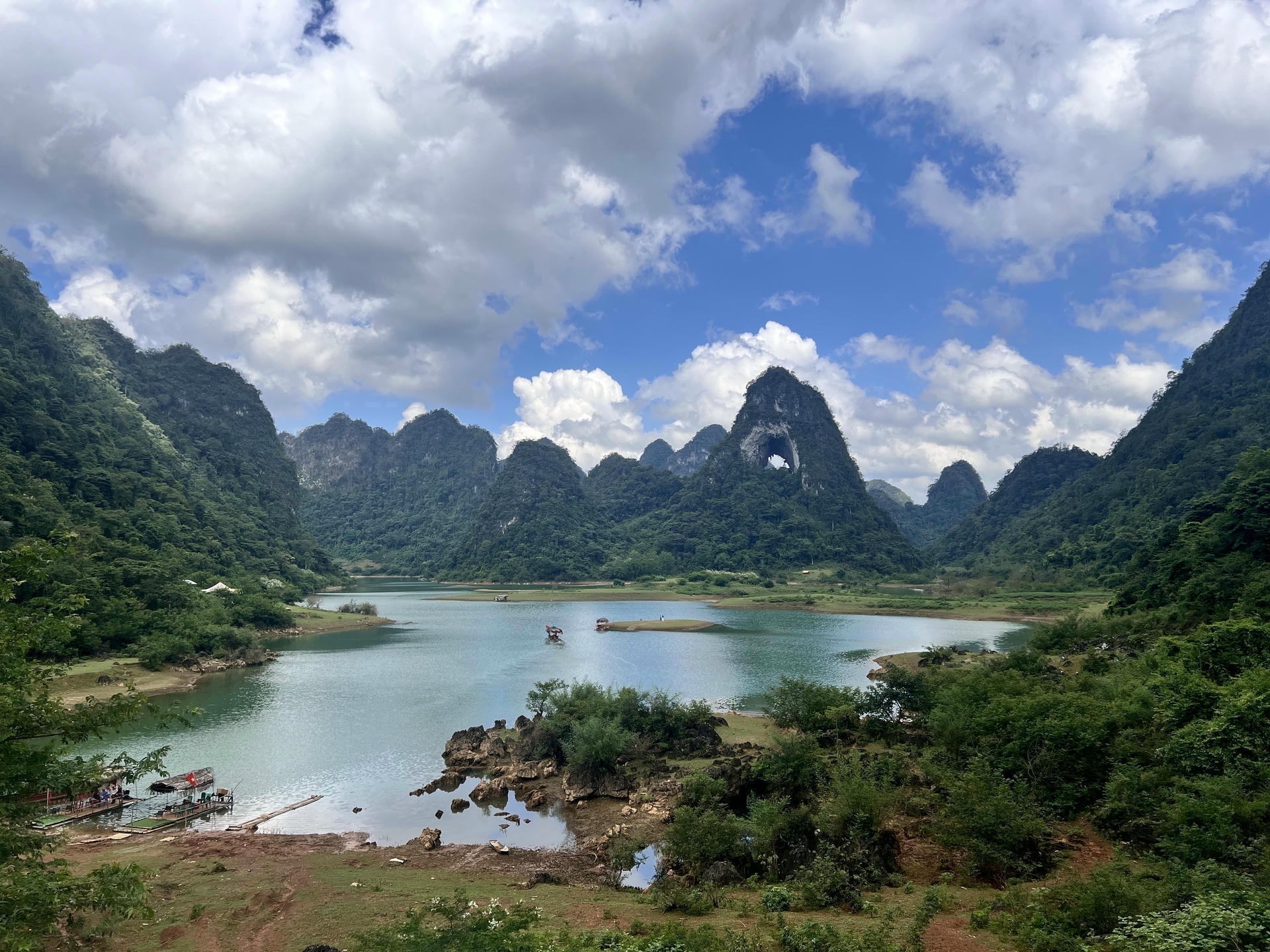 Wide panoramic view of Angel Eye Mountain with its giant round arch in Cao Bang, Vietnam.