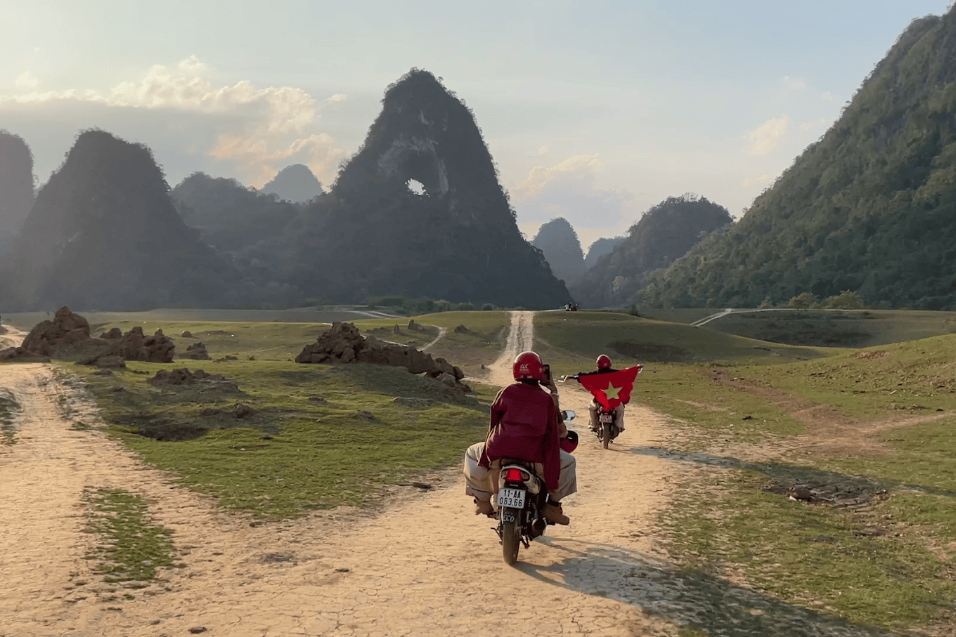 Motorbike riding across the dry meadow at the base of Angel Eye Mountain in the dry season.