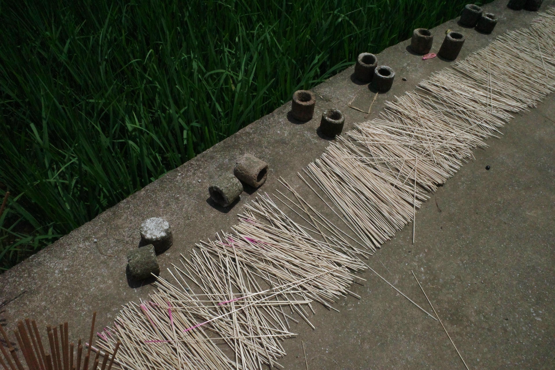 Bundles of colorful incense sticks drying in the sun at Phia Thắp incense village on the Cao Bang Loop
